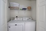 Full size washer and dryer located in the main hall across from the downstairs bath.